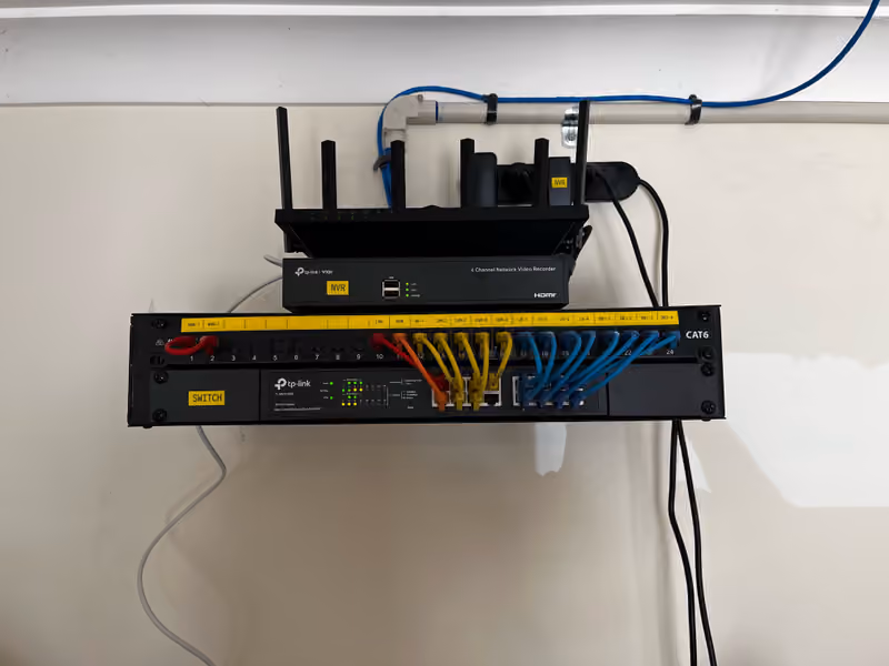 2RU wall-mount rack frame with patch panel, switch, NVR and router installed.