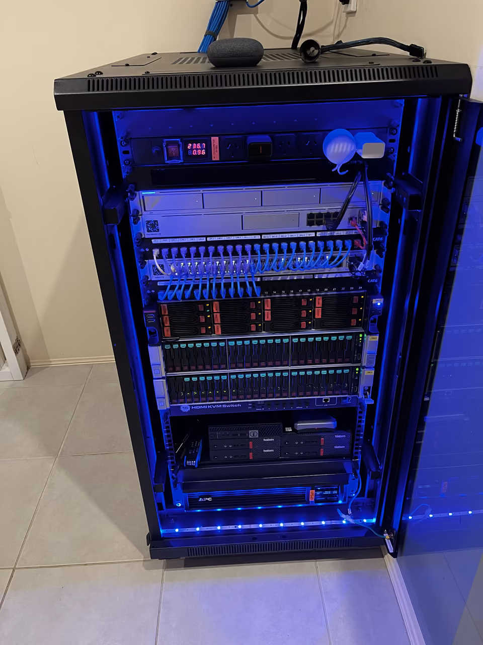 Completed network rack with labelled CAT6 patching, switching, storage, and power management